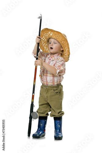 Little boy fisherman with a big stick in a straw hat