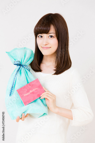 young asian woman with gift on white background