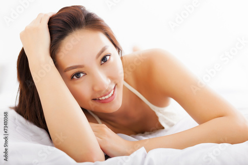 young Beautiful asian woman relaxing on the bed