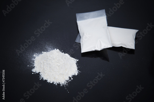 Foto Transparent plastic bags with white powder
