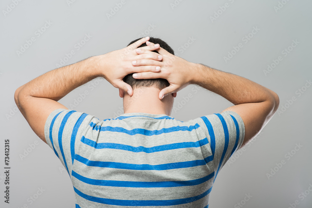 Fototapeta premium Depressed young man holding head in hands