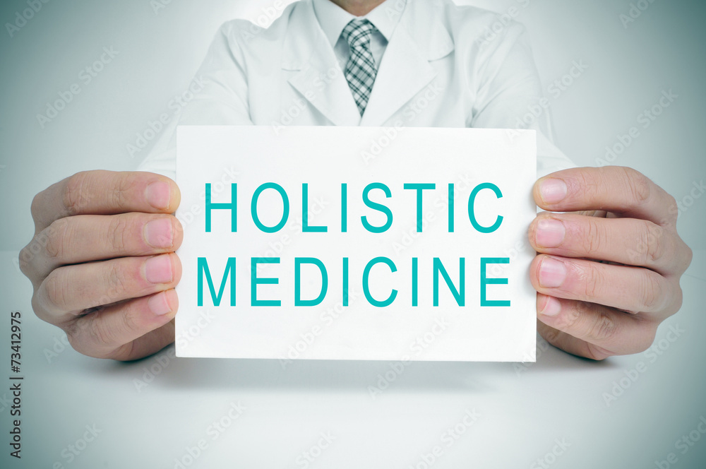 doctor with a signboard with the text holistic medicine doctor with a signboard with the text holistic medicine