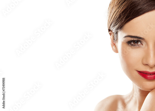 half face of a beautiful young smiling woman on white