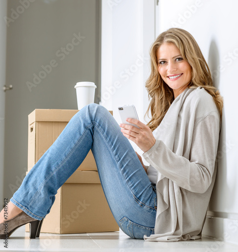 Happy woman texting in new ...
