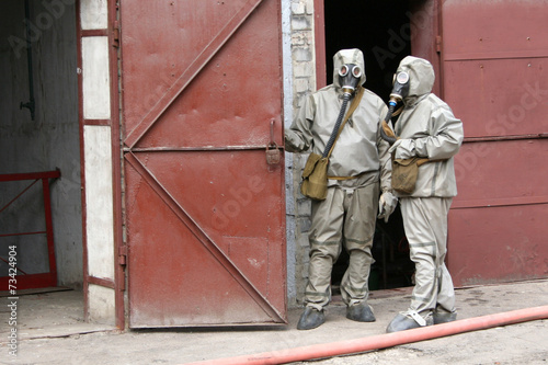 firefighters in chemical protection suit