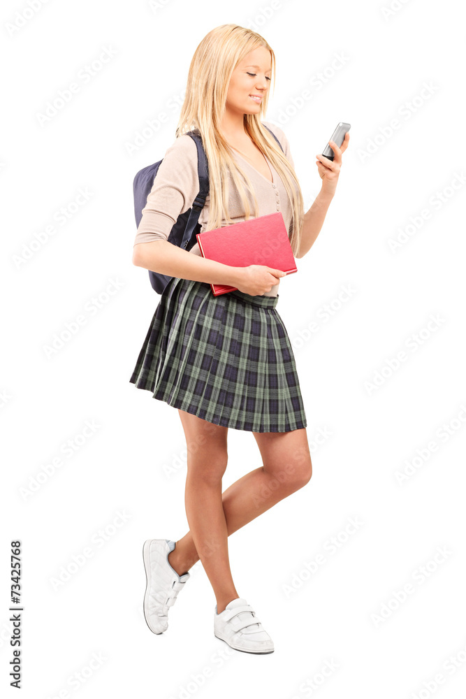 Schoolgirl looking at a cell phone Schoolgirl looking at a cell phone