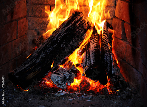 Burning fire wood in a fireplace photo