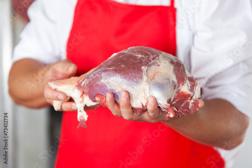 Butcher Holding Meat In Store