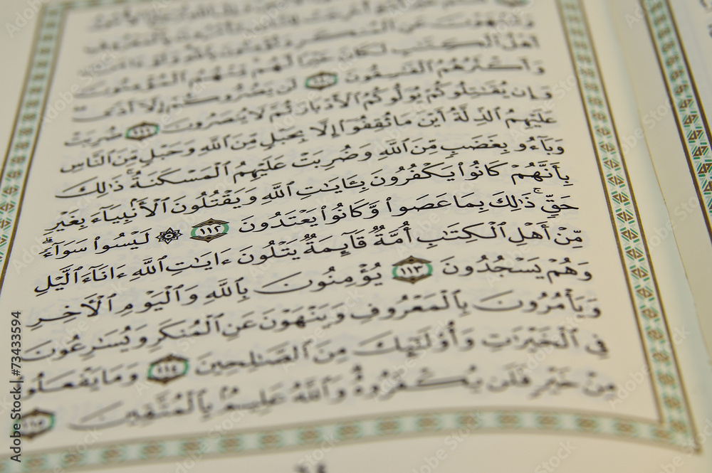 Fototapeta premium Open Koran with arabic writing visible