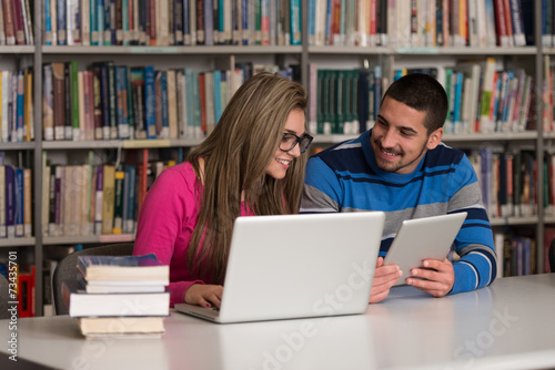 Young Students Using Their Laptop In A Library