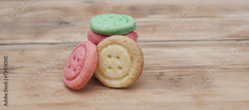 Multicolored sugar cookies on wooden background