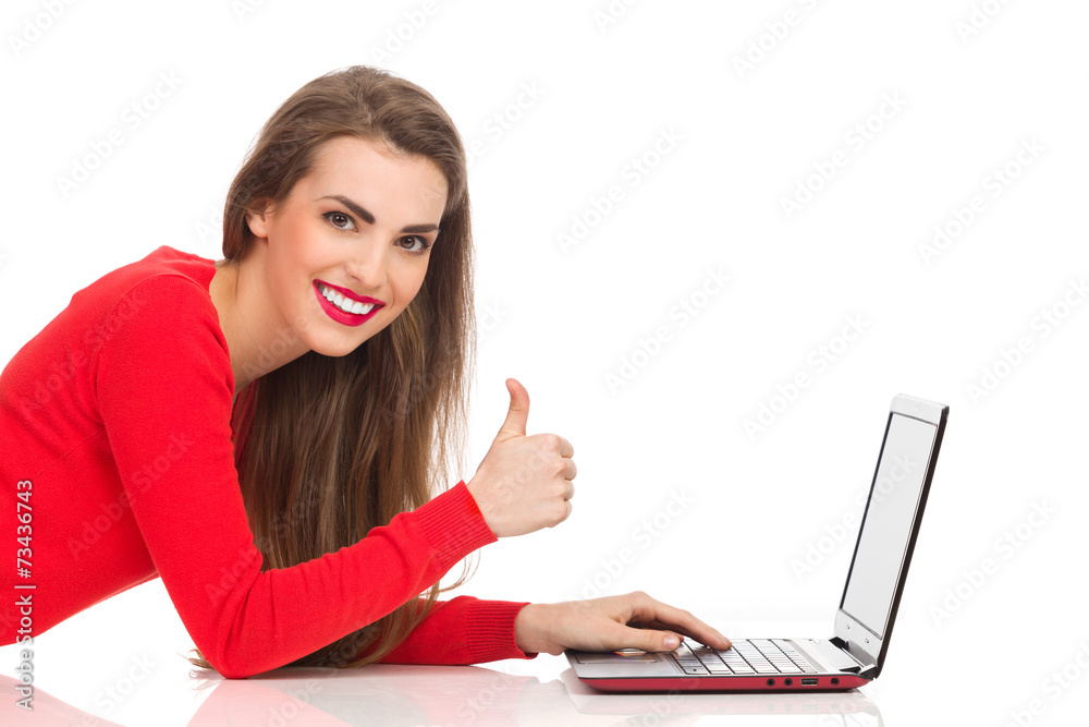 Smiling computer girl showing thumb up Smiling computer girl showing thumb up
