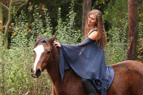 Pretty girl riding a horse without any equipment © Zuzana Tillerova