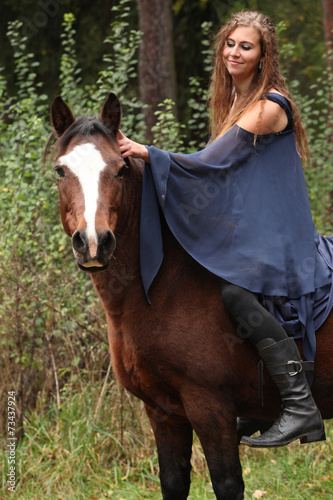 Pretty girl riding a horse without any equipment