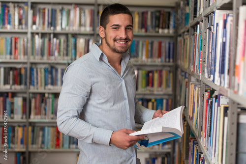 Male College Student In A Library