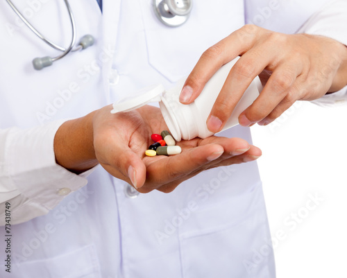 Asian male doctor with pills and pharmacy bottle