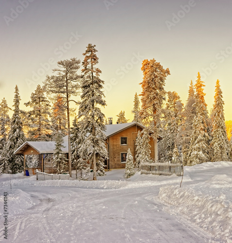 Wooden cottage house at winter Lapland photo