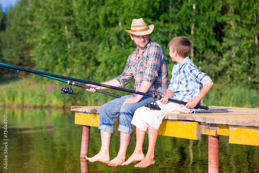 boy and his father fishing togethe boy and his father fishing togethe