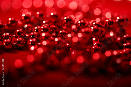 red beads with blurred lights bokeh for Christmas atmosphere