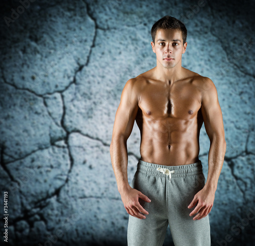 young male bodybuilder with bare muscular torso