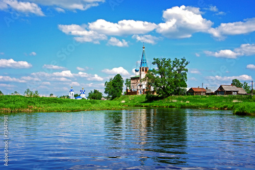 View of River with ancient Church in old russian city. Russia