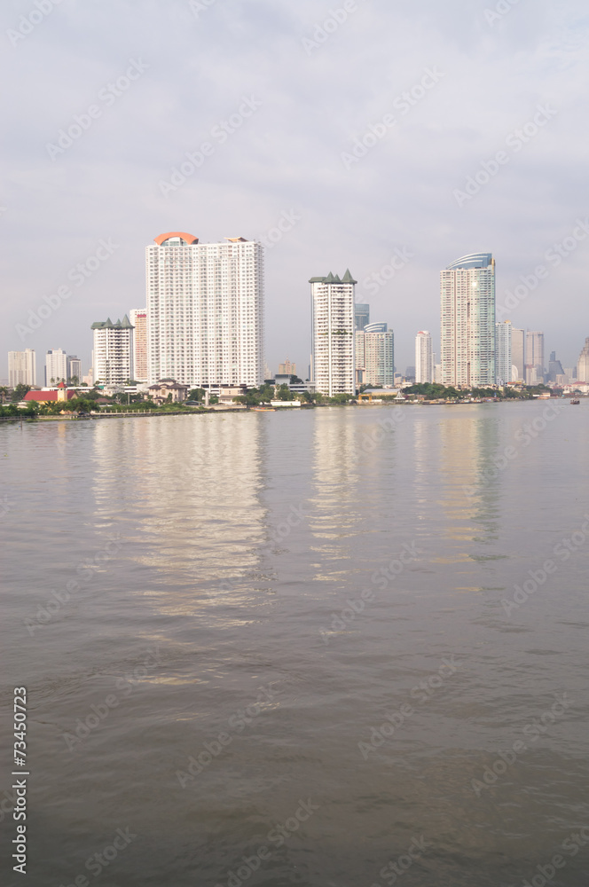 tall buildings near the river in Bangkok of Thailand