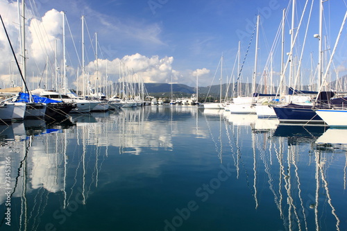 yacht and boat reflections in marina harbour