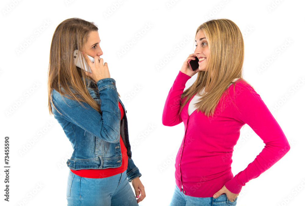 Student women talking to mobile over white background Student women talking to mobile over white background
