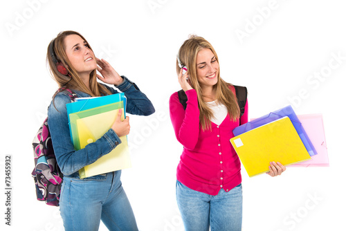 Students listening music over white background
