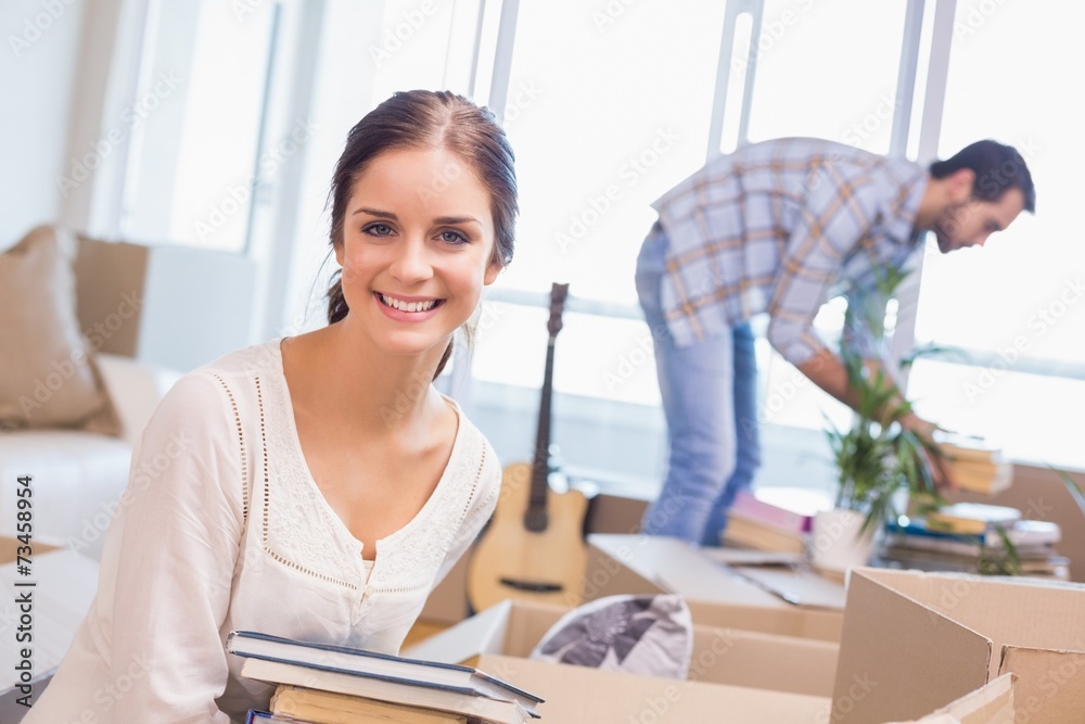 Obraz premium Cute couple unpacking cardboard boxes