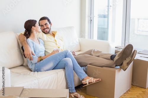 Young couple taking a break from unpacking