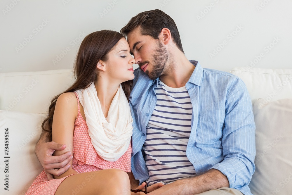 Naklejka premium Young couple relaxing on couch