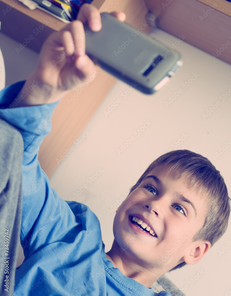boy taking selfie with smart phone boy taking selfie with smart phone