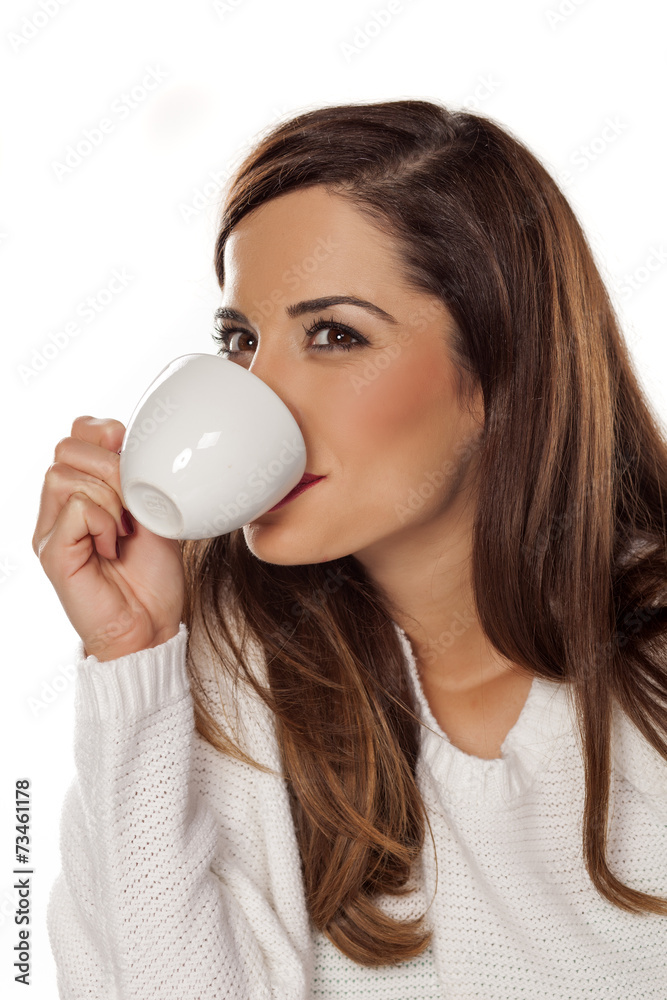 Beautiful young woman enjoying a morning coffee Beautiful young woman enjoying a morning coffee