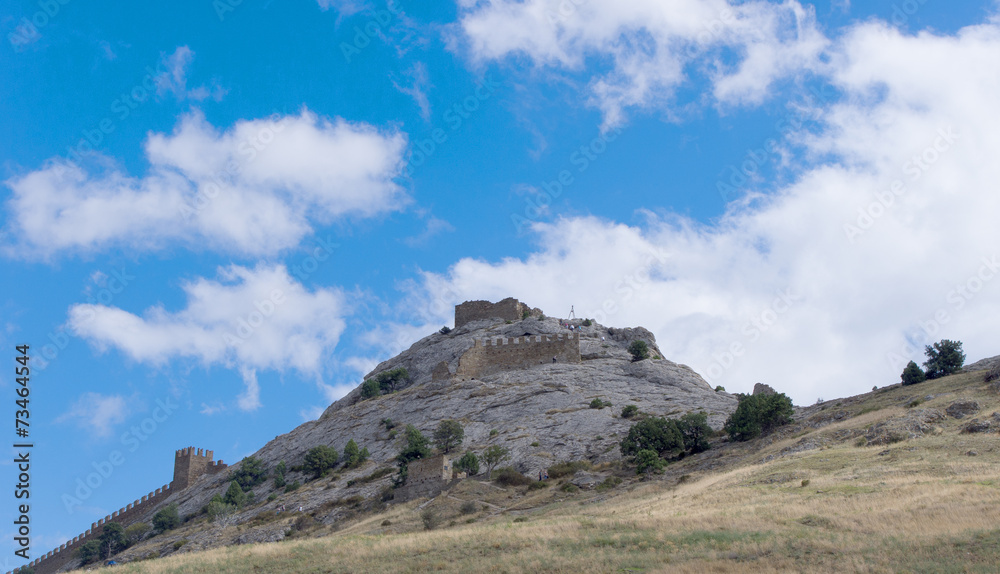 Part of old castle on the rock on sky background