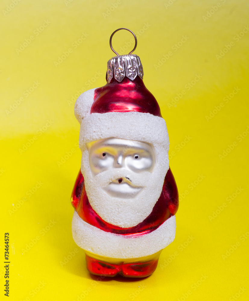 Red toy Santa on yellow background