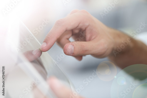 Closeup of hand sliding on digital tablet