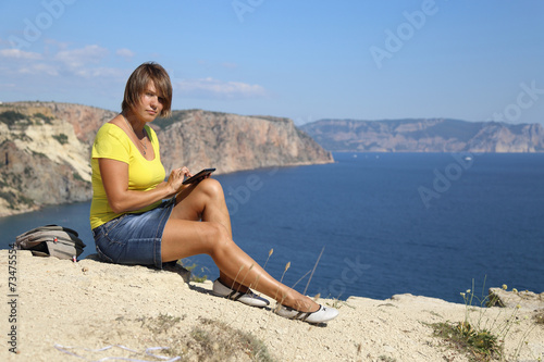 woman with tablet computer on the beautiful coast