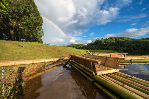 Wooden raft with the clear sky and rainbow