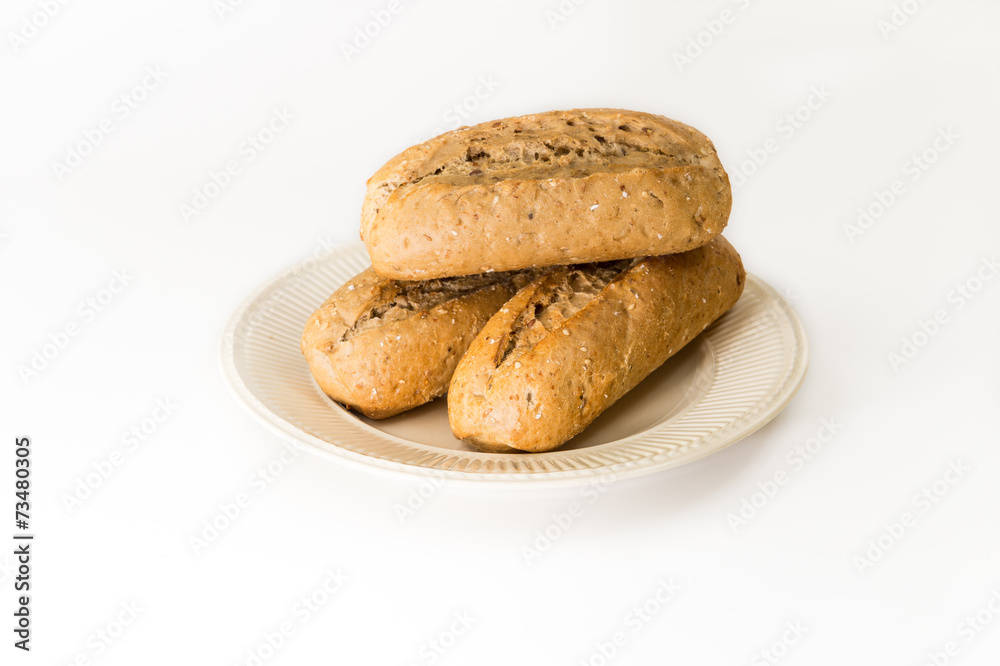 Three baguettes on an off-white plate Three baguettes on an off-white plate