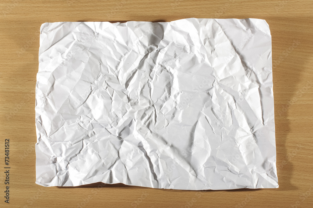 Folded white sheet of paper on the table Folded white sheet of paper on the table