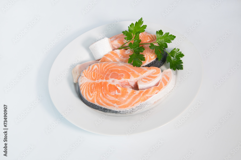 Fresh trout on the white plate, served with parsley Fresh trout on the white plate, served with parsley