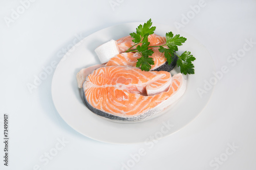 Fresh trout on the white plate, served with parsley