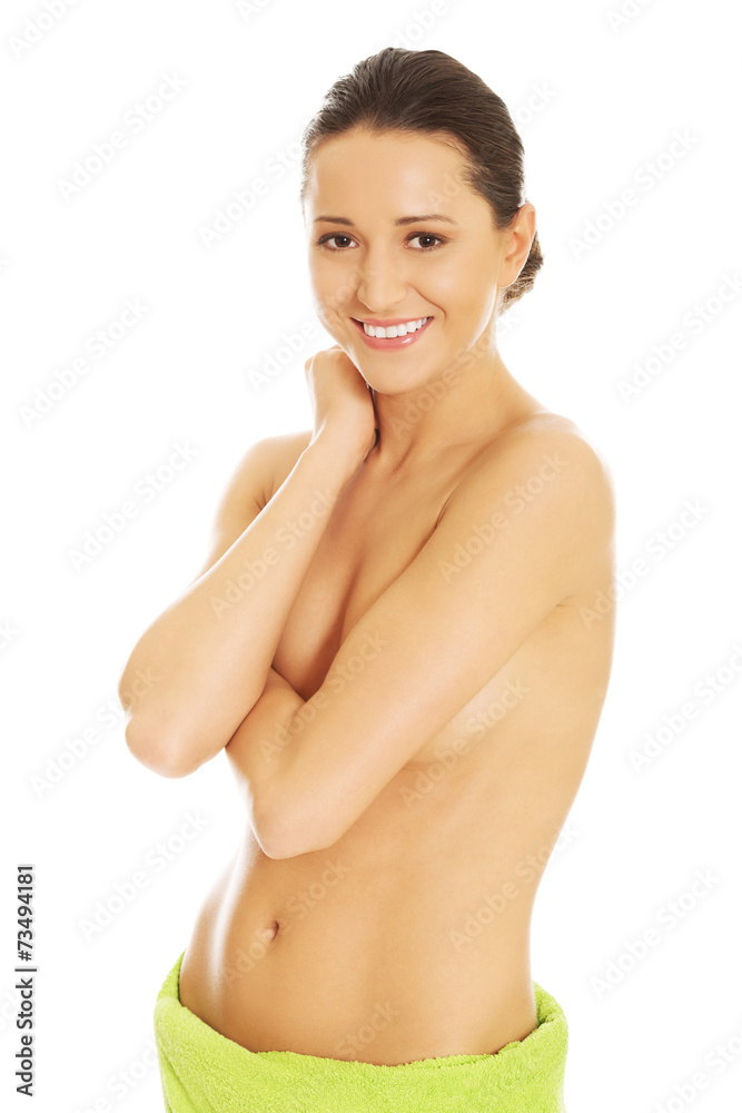 Fototapeta premium Nude woman wrapped in towel on hips