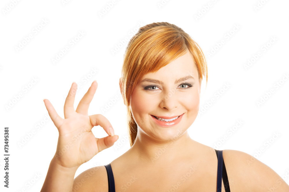 Portrait of overweight woman showing OK sign Portrait of overweight woman showing OK sign