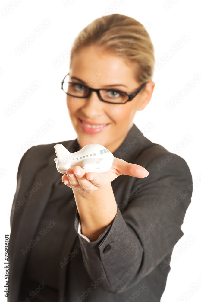 Businesswoman with plane toy in hand