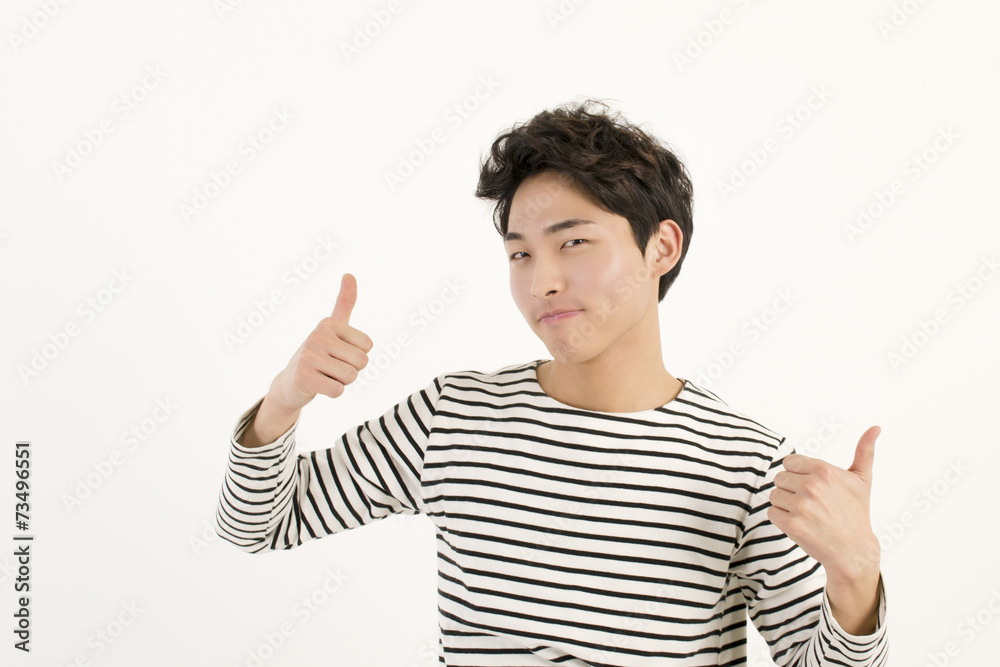 Young asian man thumbs up gesture of approval Young asian man thumbs up gesture of approval