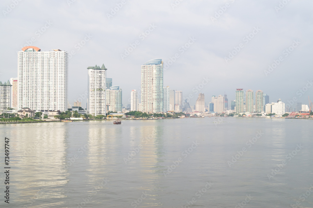 buildings, river, trees and boat in Bangkok of Thailand
