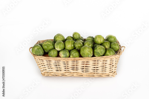 Basket full of brussel sprouts isolated on white