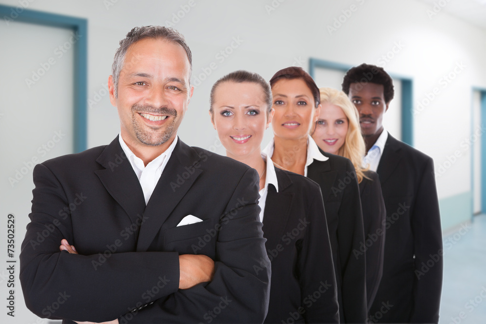 Multiethnic Businesspeople Standing In A Row At Office